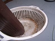 plastic colander in light rain